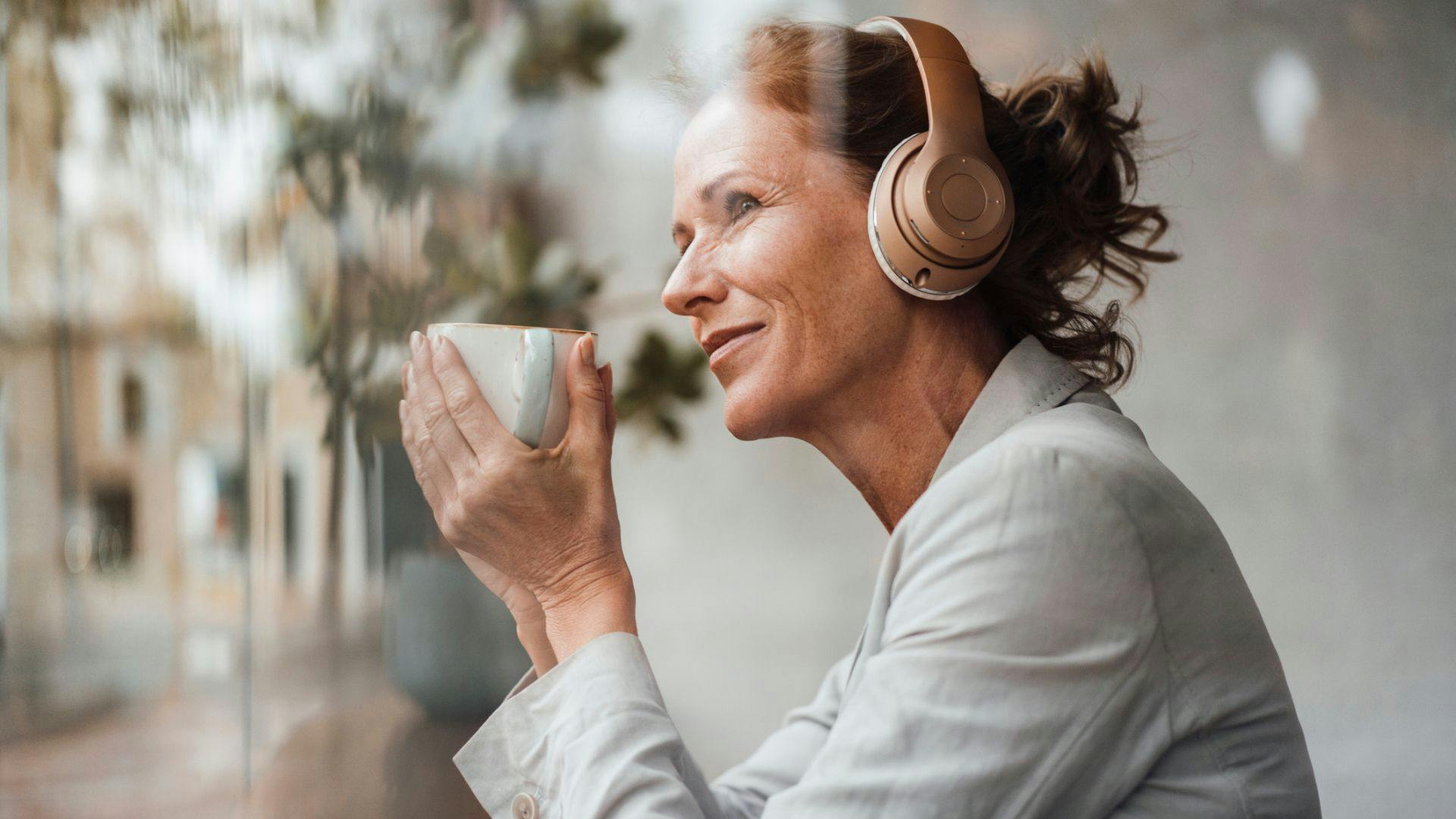 Business Executive Commuter Listening in Coffee Shop